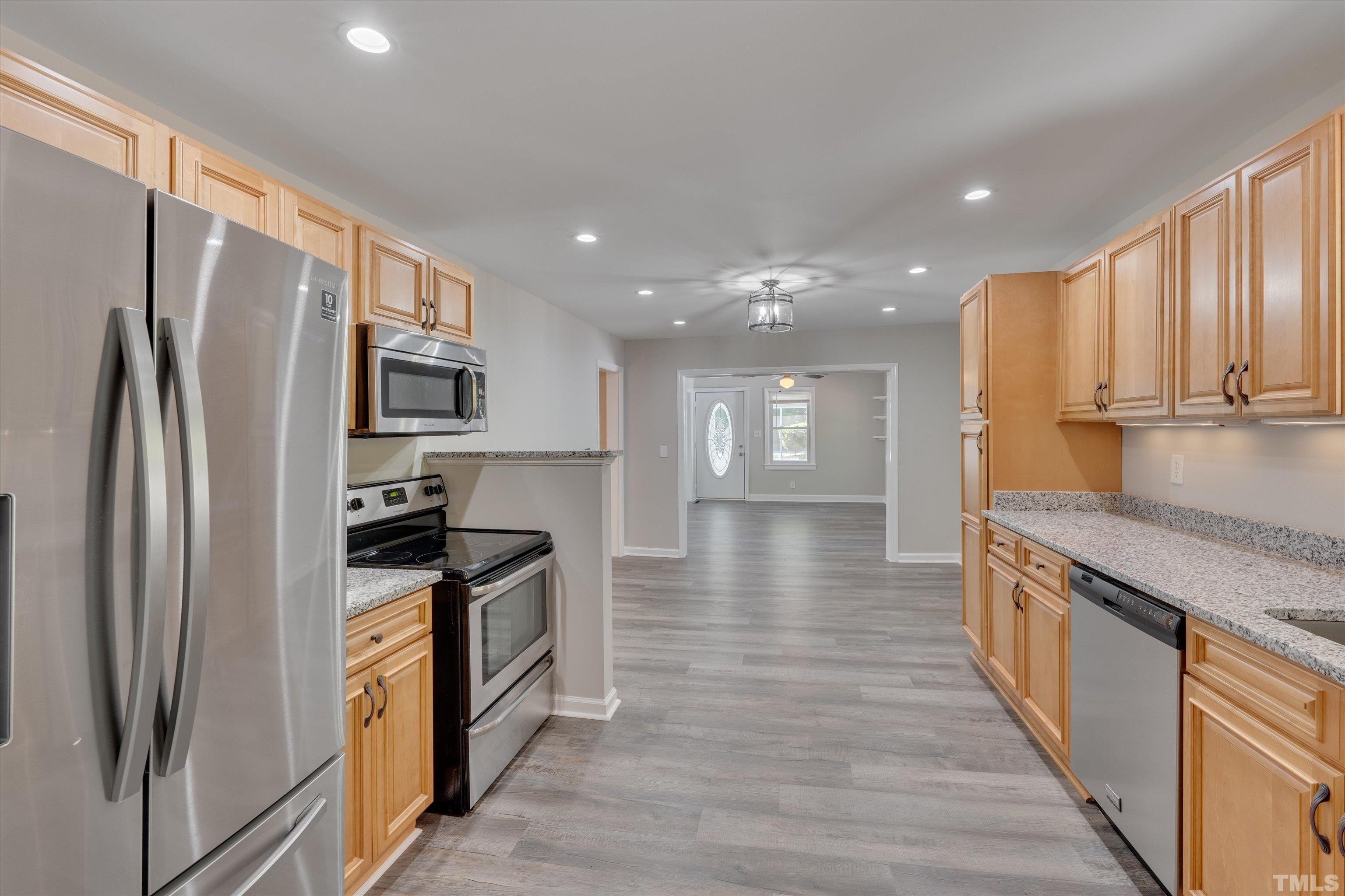 308 South Mineral Springs Road Durham, NC 27703 - Photo 15 of 42 a kitchen with stainless steel appliances granite countertop a refrigerator a stove and a sink