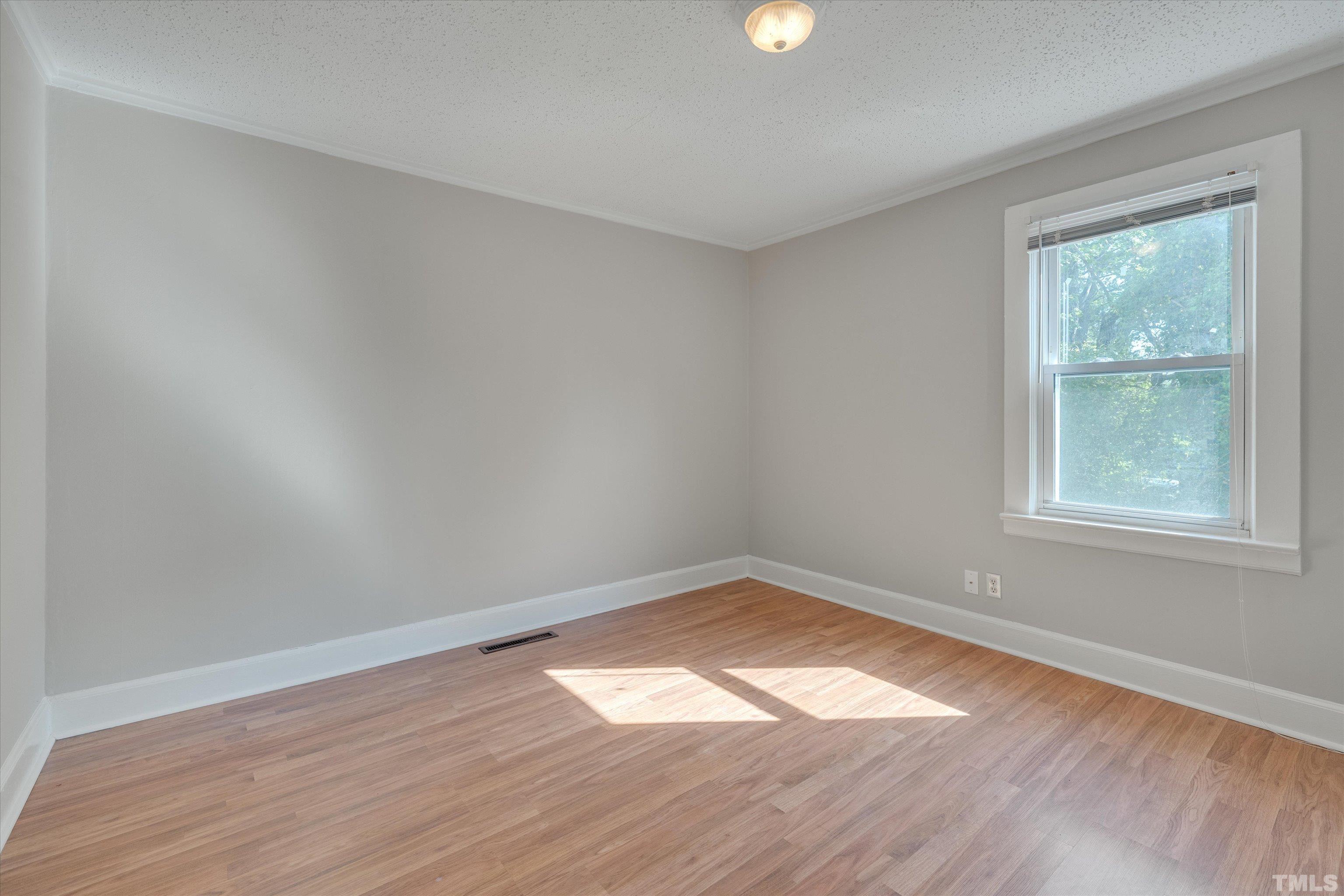 308 South Mineral Springs Road Durham, NC 27703 - Photo 24 of 42 an empty room with wooden floor and windows