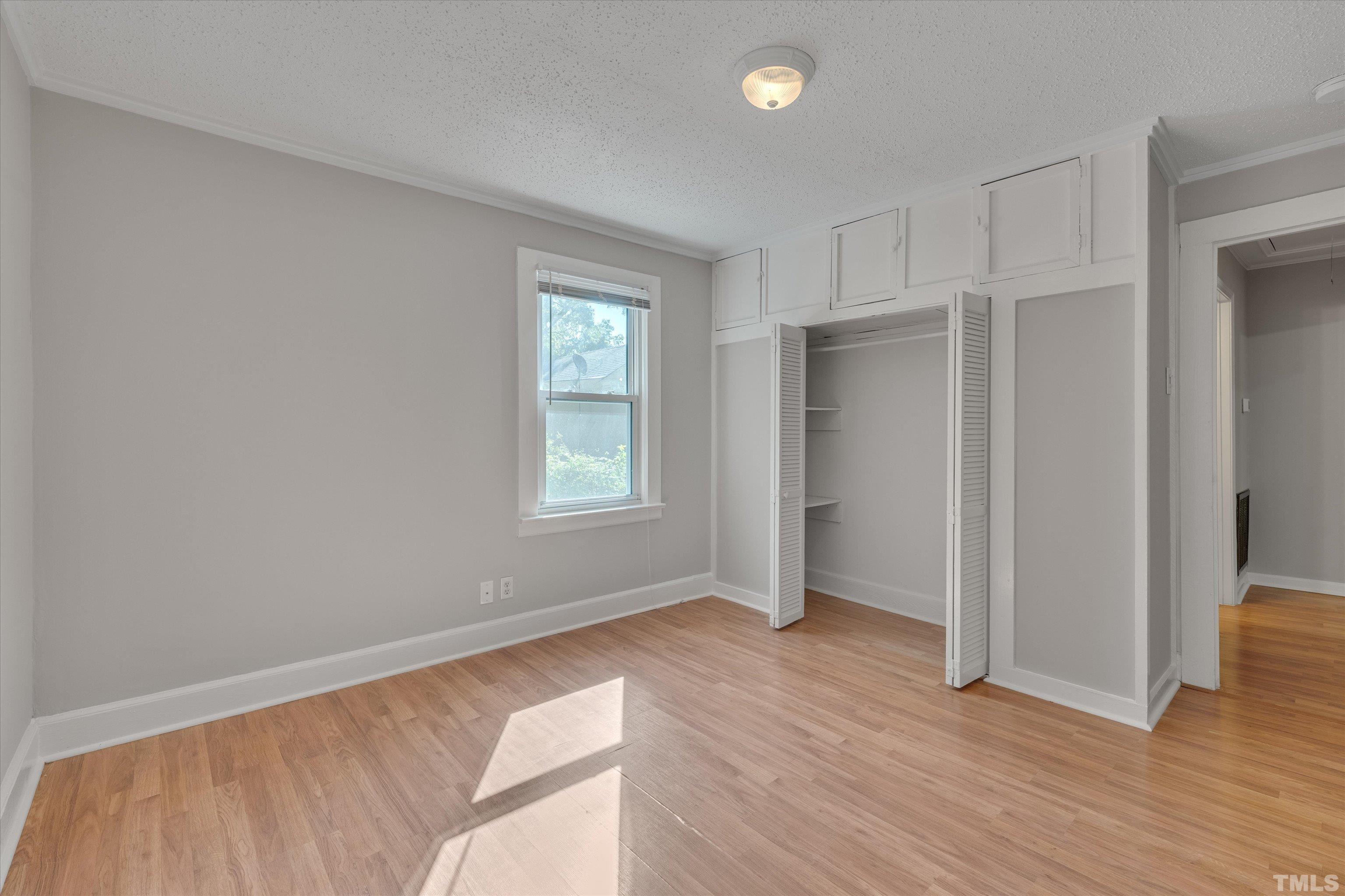308 South Mineral Springs Road Durham, NC 27703 - Photo 25 of 42 an empty room with wooden floor and windows