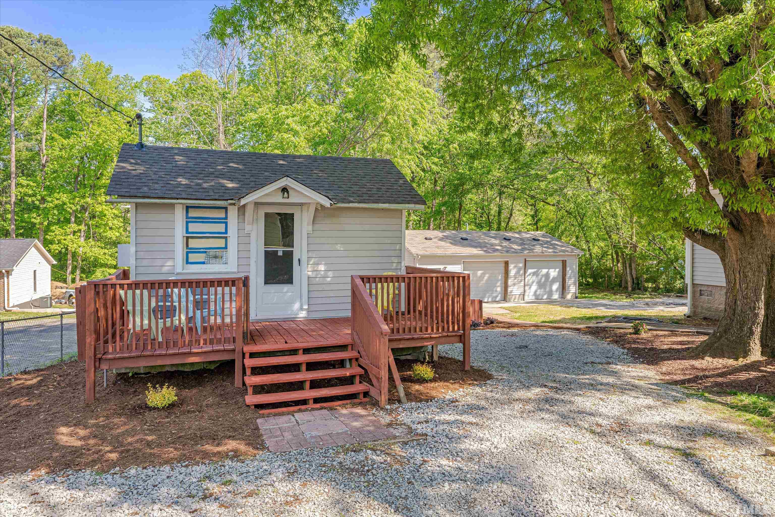 308 South Mineral Springs Road Durham, NC 27703 - Photo 30 of 42 a view of backyard of house with wooden deck and outdoor seating