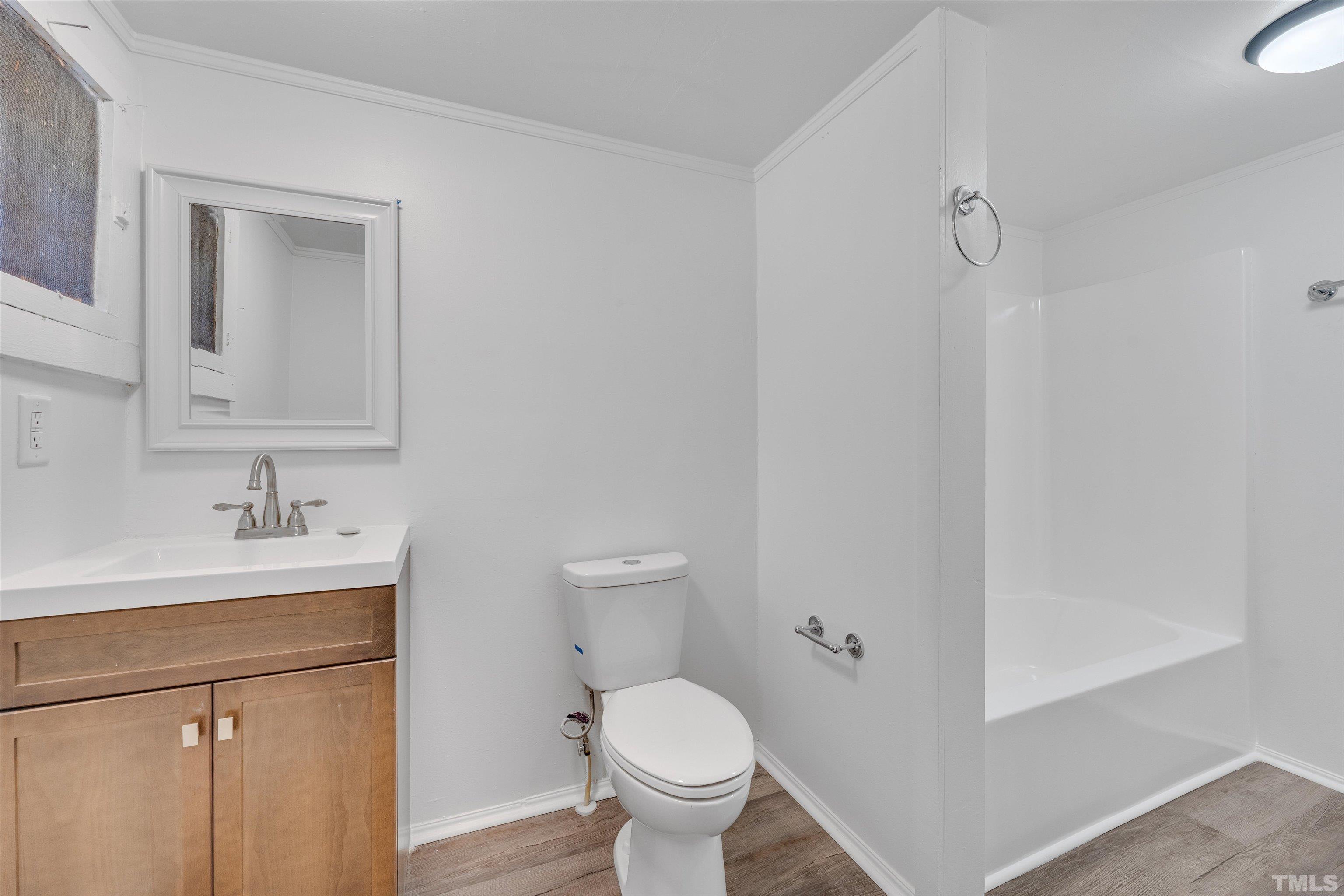 308 South Mineral Springs Road Durham, NC 27703 - Photo 34 of 42 a bathroom with a toilet sink vanity and mirror