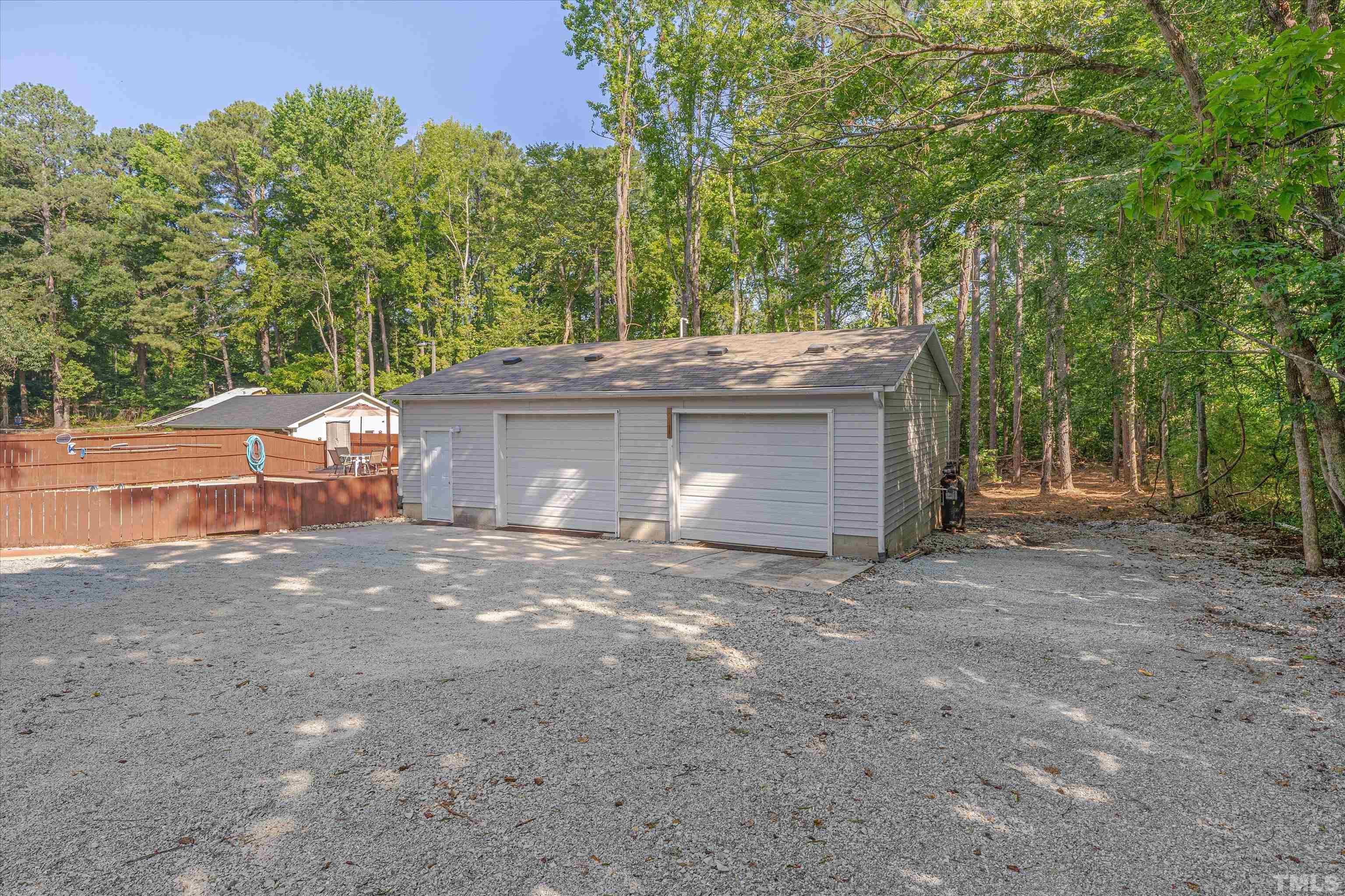 308 South Mineral Springs Road Durham, NC 27703 - Photo 39 of 42 a view of a house with a garage and a fire pit