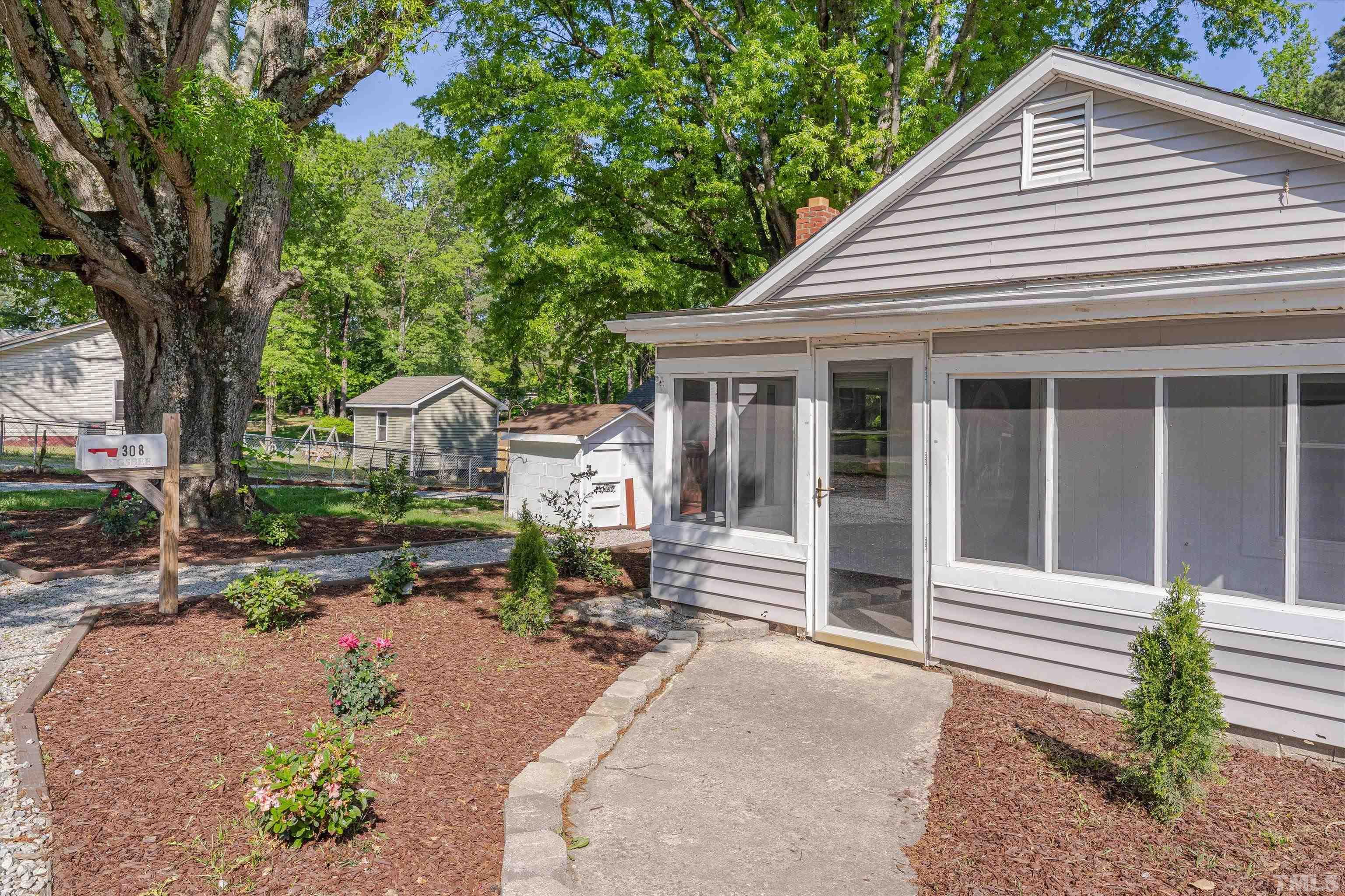 308 South Mineral Springs Road Durham, NC 27703 - Photo 7 of 42 a front view of a house with garden