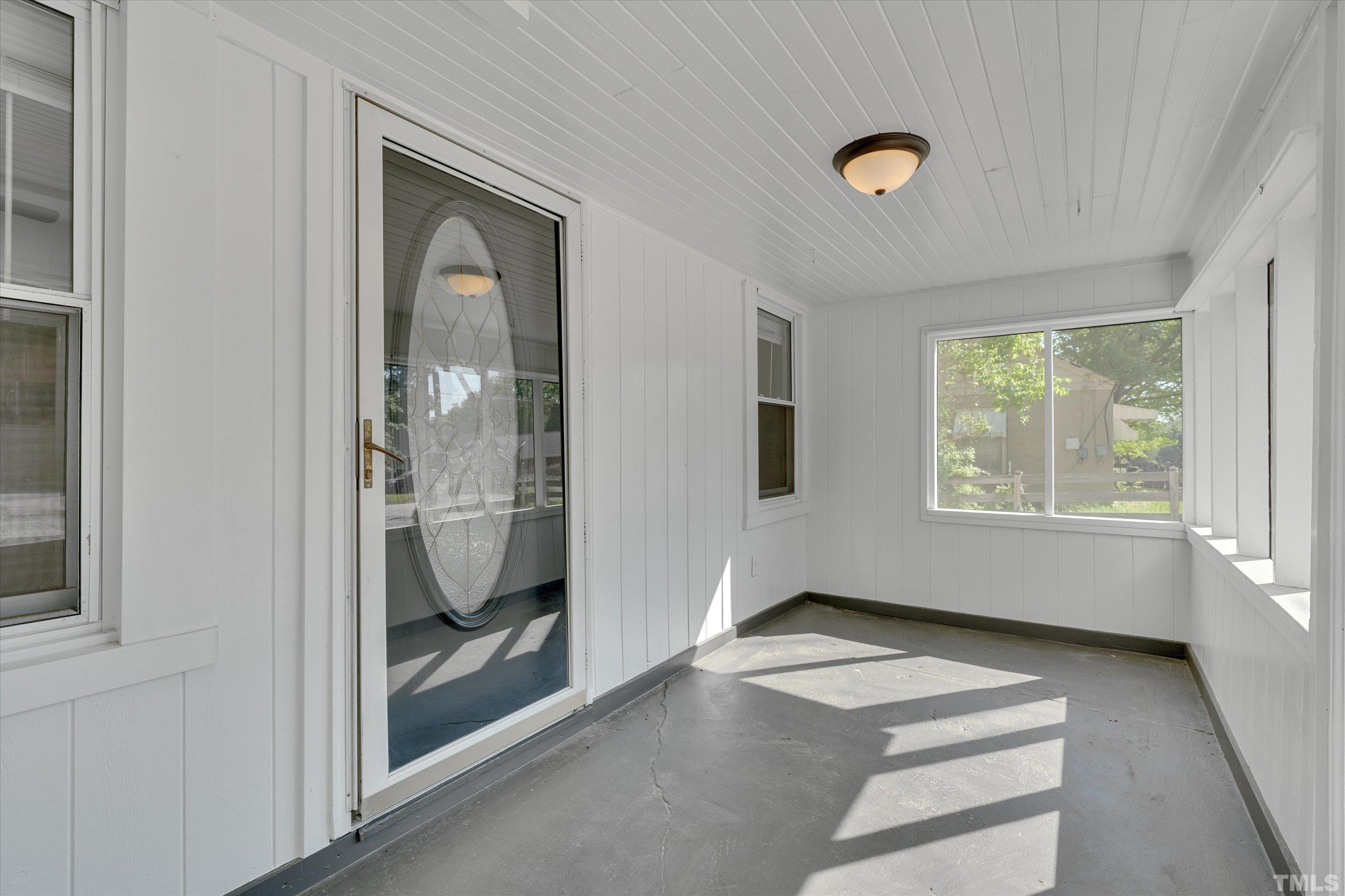 308 South Mineral Springs Road Durham, NC 27703 - Photo 8 of 42 a view of an empty room with glass door and windows