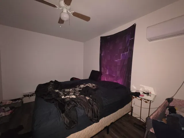 a bed sitting in a bedroom next to a window