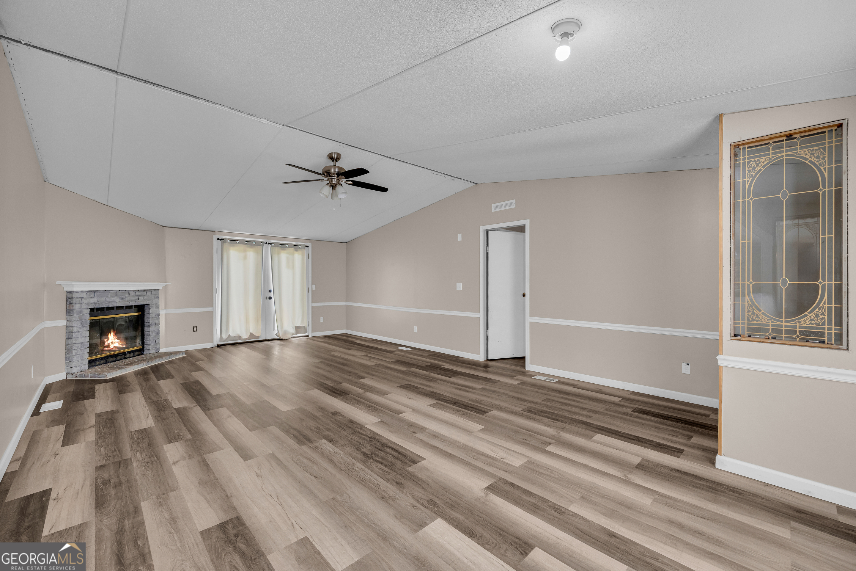 35 Jordan Loop Toccoa, GA 30577 - Photo 27 of 49 wooden floor in an empty room with a fireplace