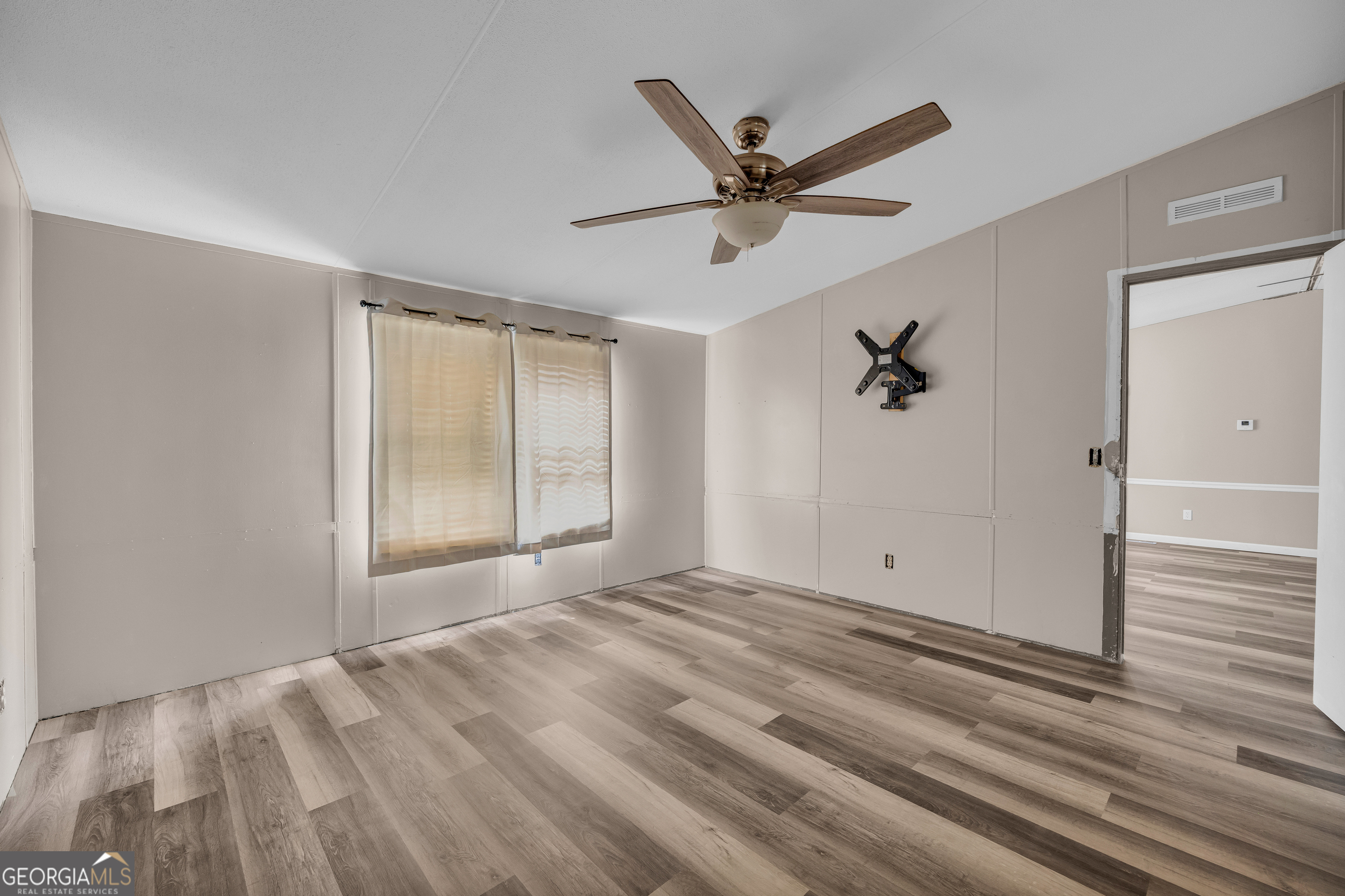 35 Jordan Loop Toccoa, GA 30577 - Photo 29 of 49 a view of empty room with wooden floor and fan