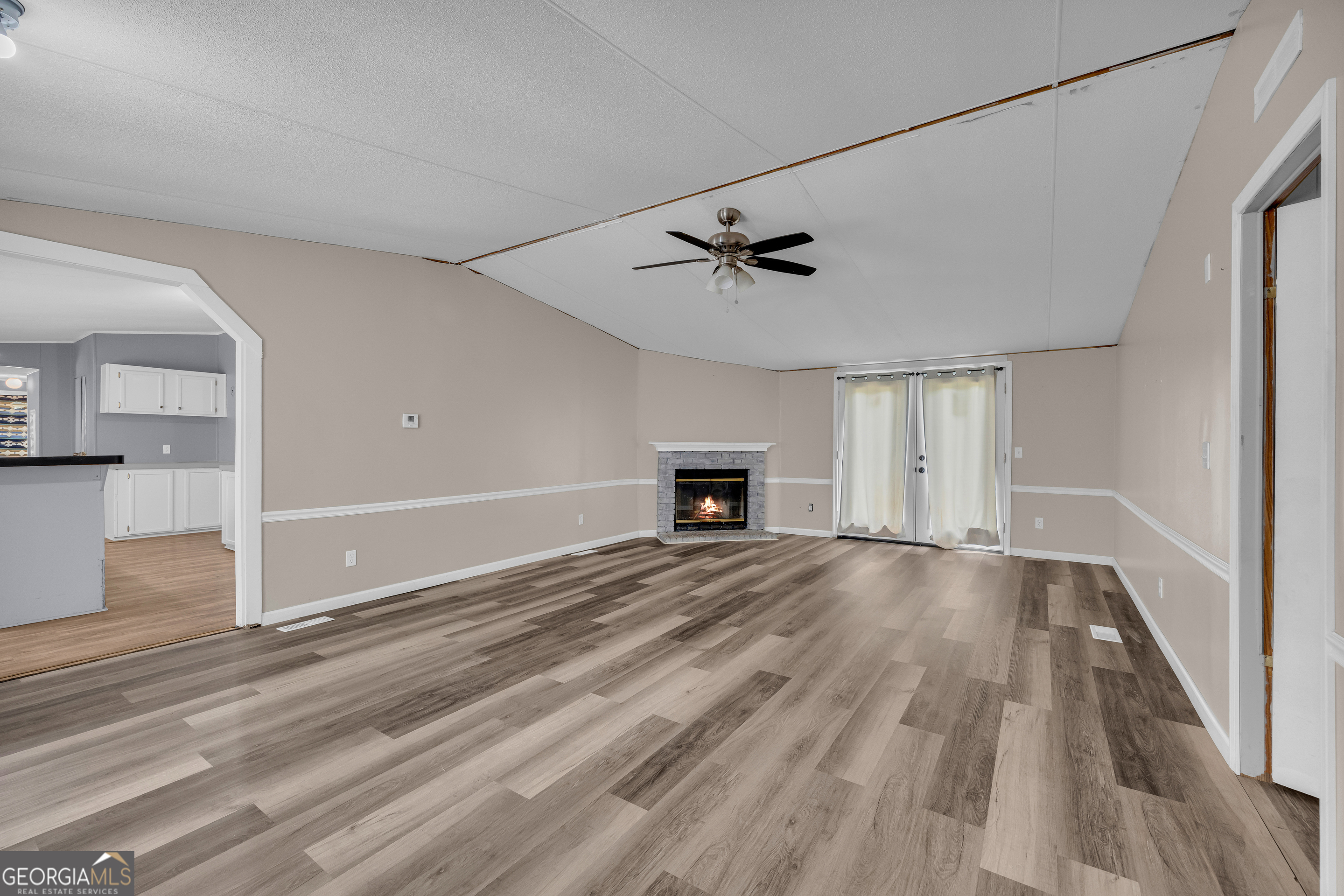 35 Jordan Loop Toccoa, GA 30577 - Photo 4 of 49 a view of empty room with wooden floor and fireplace