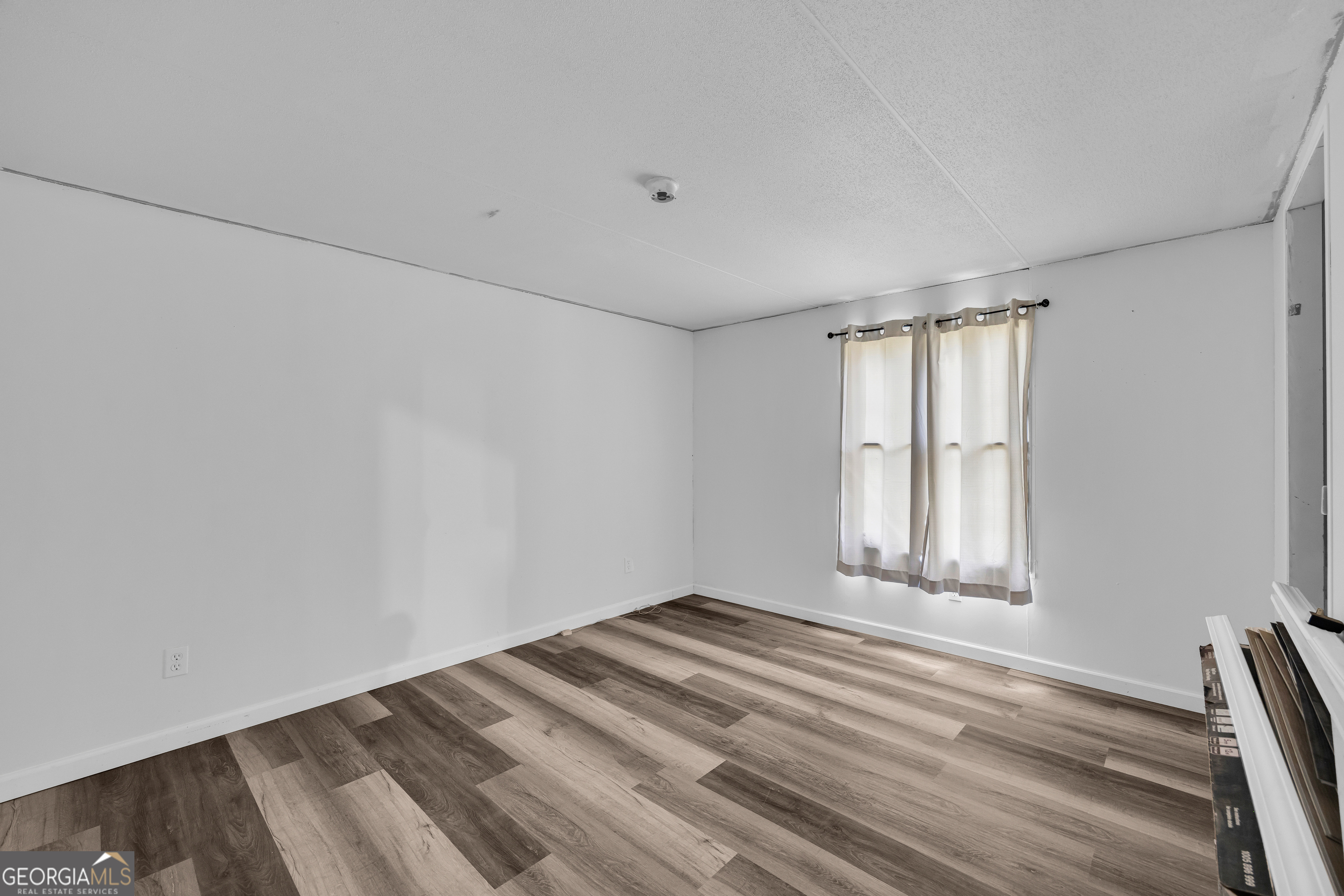 35 Jordan Loop Toccoa, GA 30577 - Photo 45 of 49 a view of empty room with wooden floor and fan