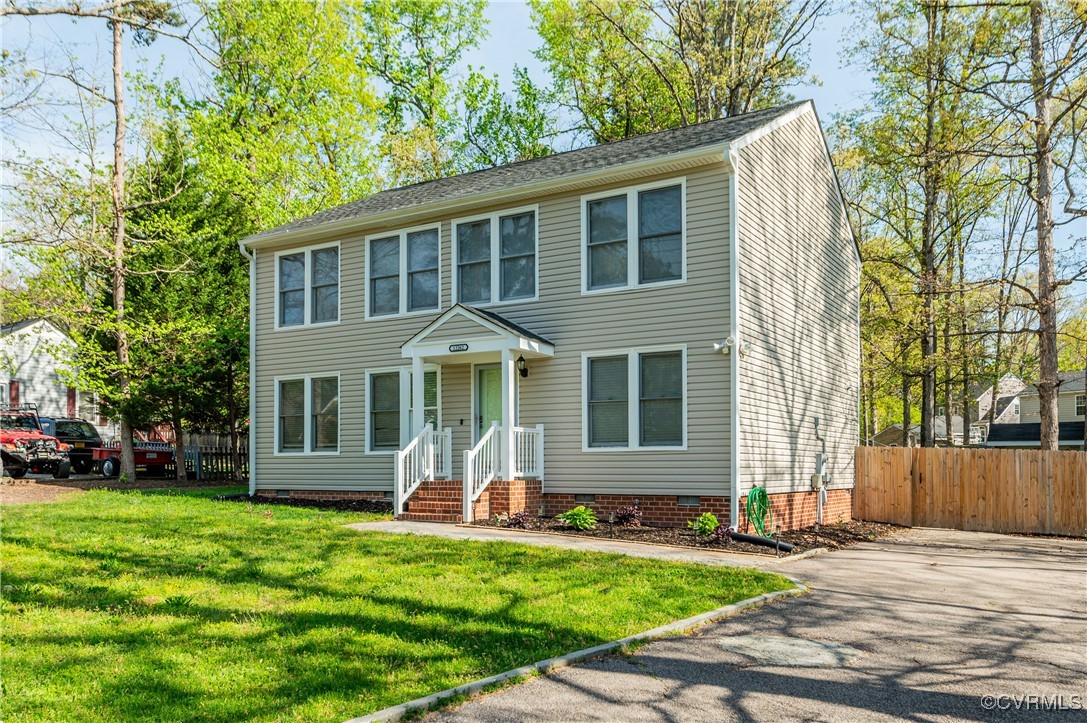 Colonial home featuring a front lawn, crawl space,