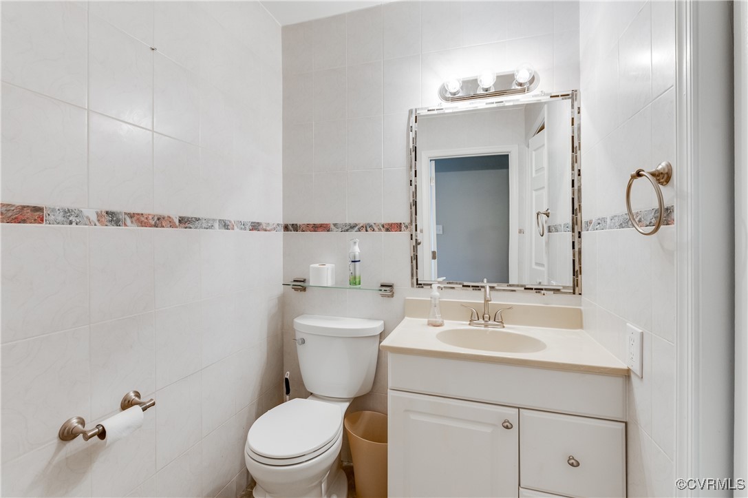 12262 Church Road Henrico, VA 23233 - Photo 20 of 50 Half bathroom featuring tile walls, toilet, and va