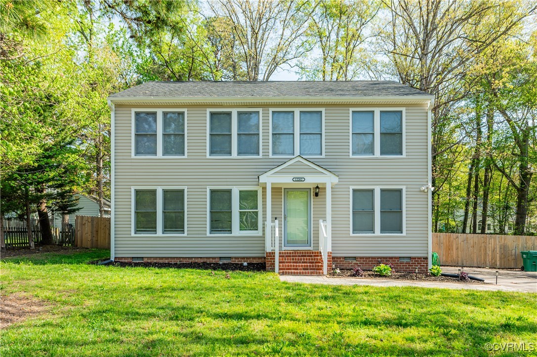 Colonial house with a front lawn, crawl space, and