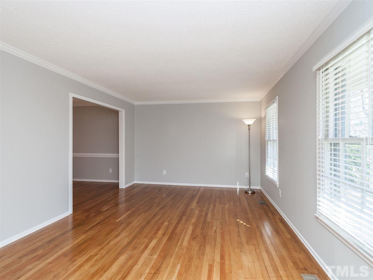 3000 Morningside Drive Raleigh, NC 27607 - Photo 2 of 25 an empty room with wooden floor and windows