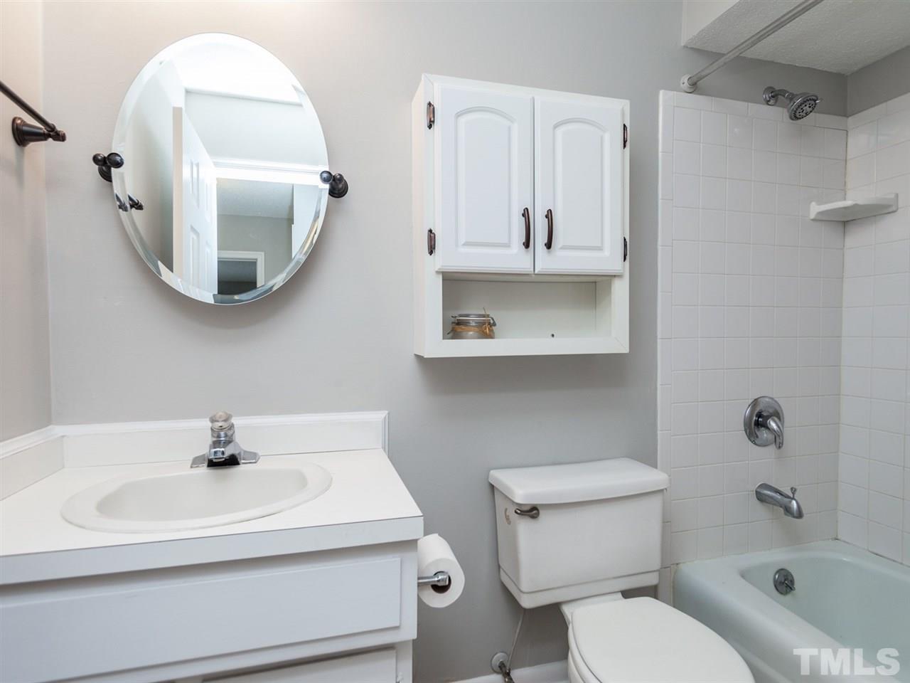 3000 Morningside Drive Raleigh, NC 27607 - Photo 13 of 25 a bathroom with a sink a toilet and a mirror