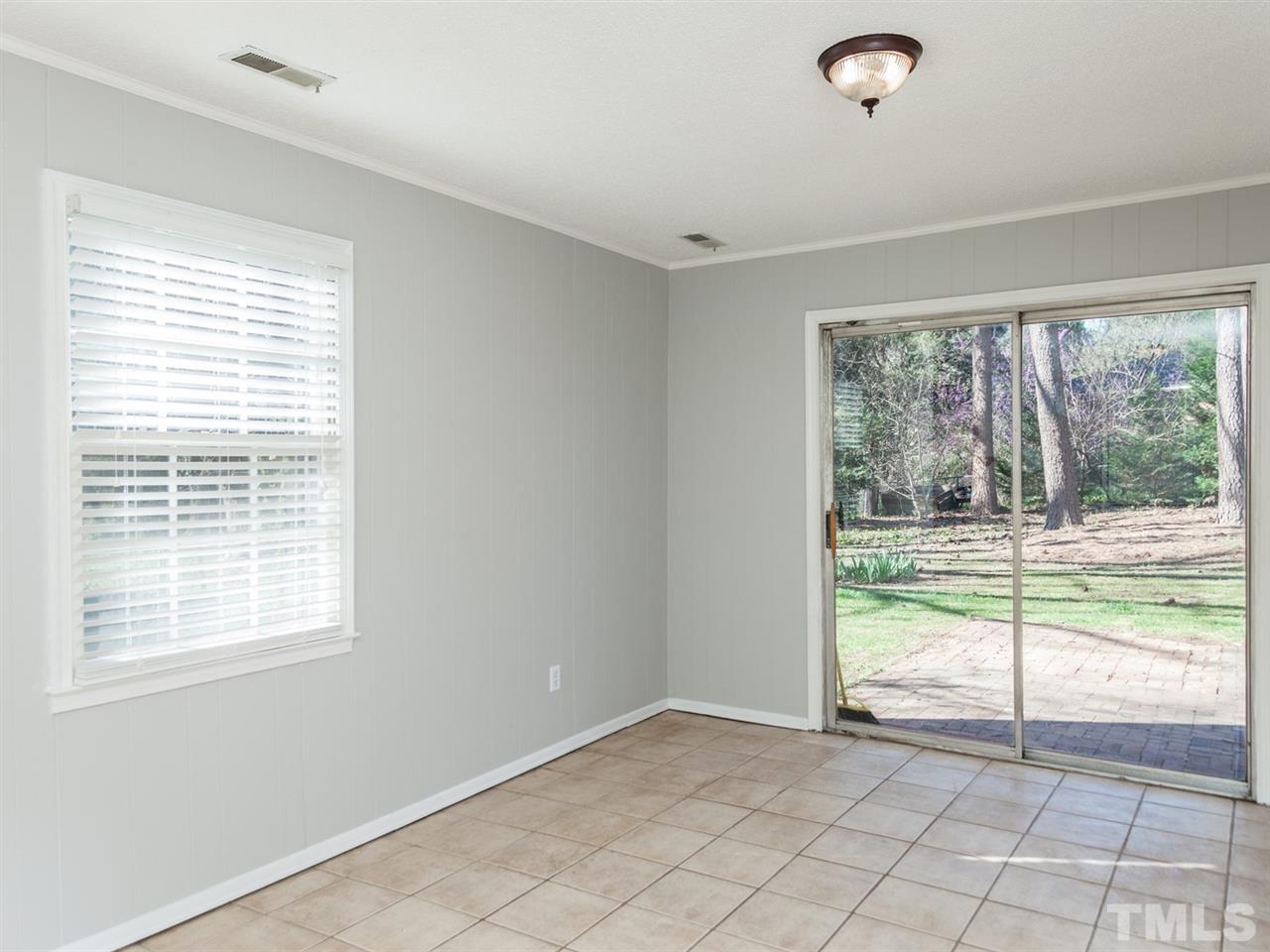 3000 Morningside Drive Raleigh, NC 27607 - Photo 20 of 25 a view of an empty room with wooden floor and a window