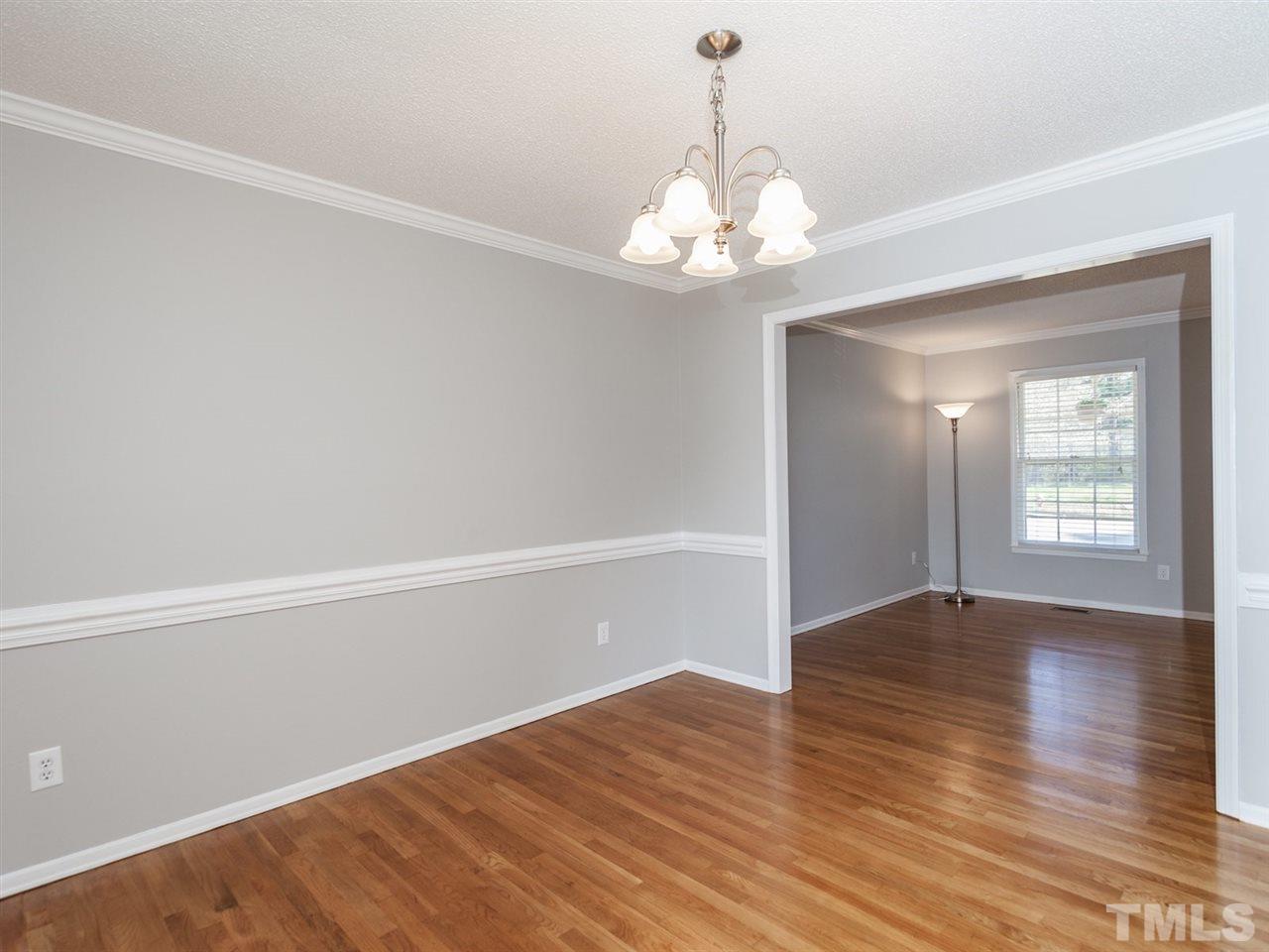 3000 Morningside Drive Raleigh, NC 27607 - Photo 3 of 25 a view of an empty room with wooden floor and a window