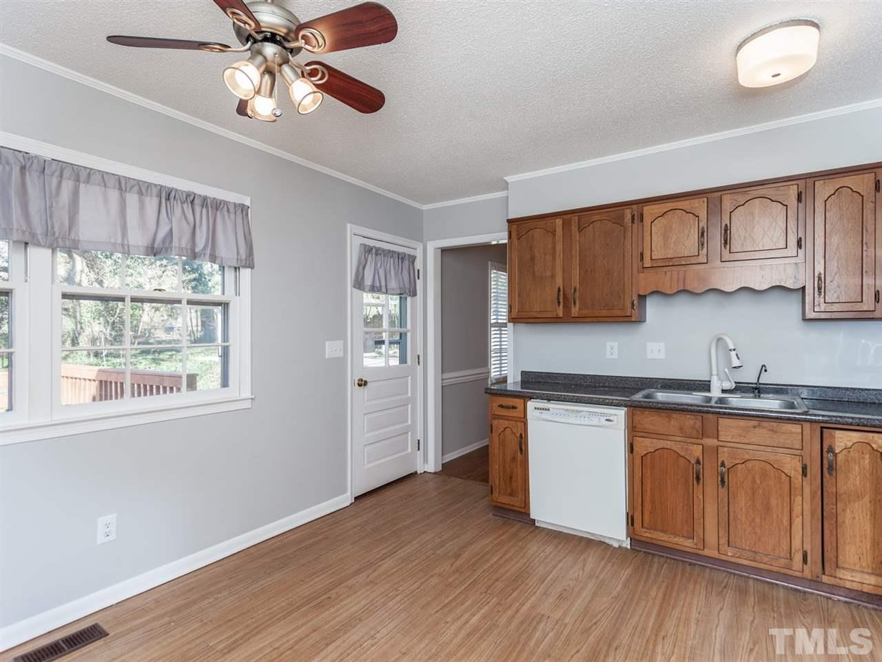 3000 Morningside Drive Raleigh, NC 27607 - Photo 5 of 25 a kitchen with stainless steel appliances granite countertop a sink cabinets and wooden floor