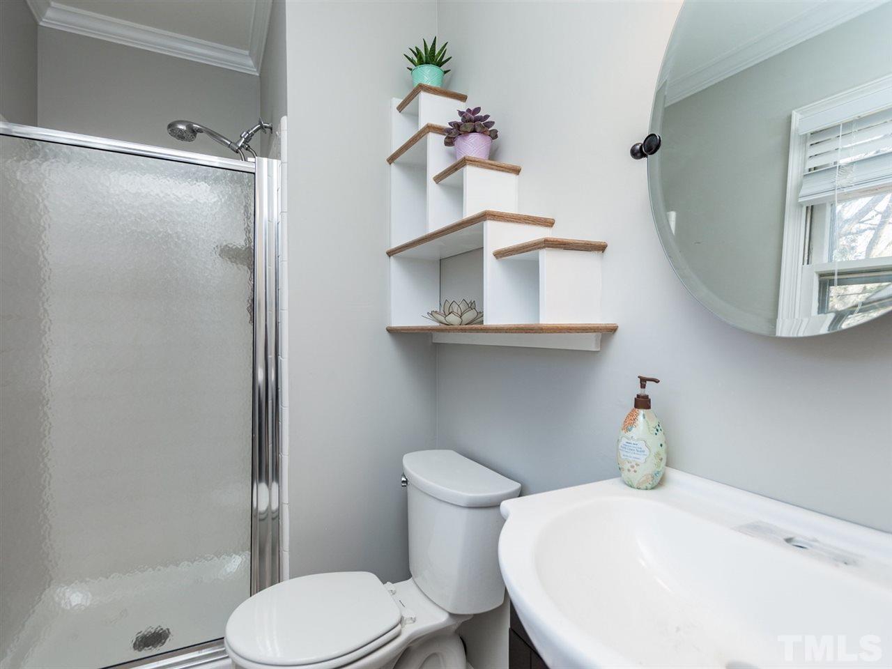3000 Morningside Drive Raleigh, NC 27607 - Photo 8 of 25 a bathroom with a toilet sink and mirror