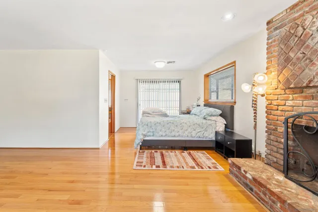 a large kitchen with stainless steel appliances granite countertop a large stove top oven a sink dishwasher and cabinets with wooden floor