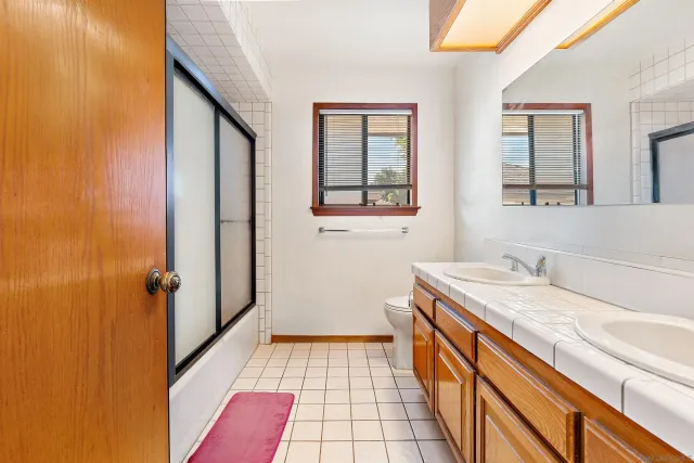 a spacious bedroom with a bed and a ceiling fan