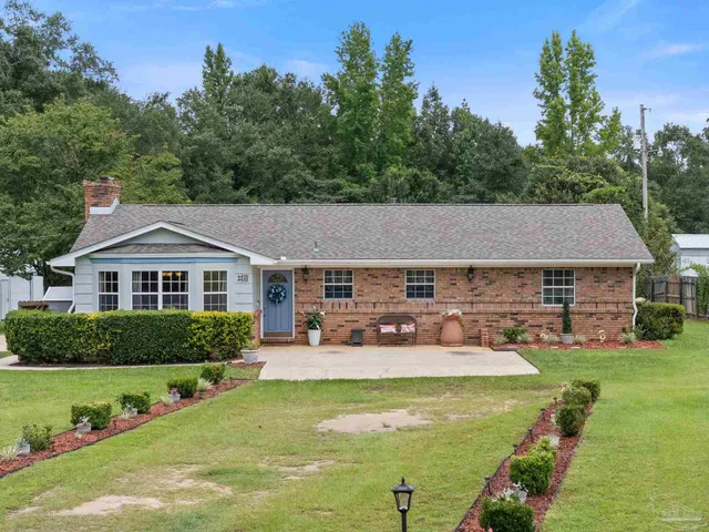 a front view of a house with garden