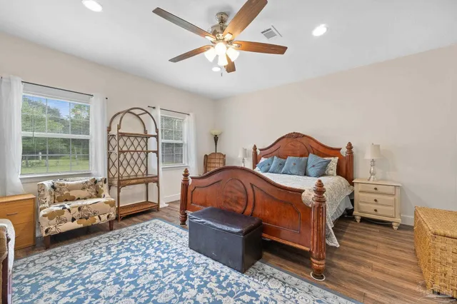 a bedroom with a bed and ceiling fan