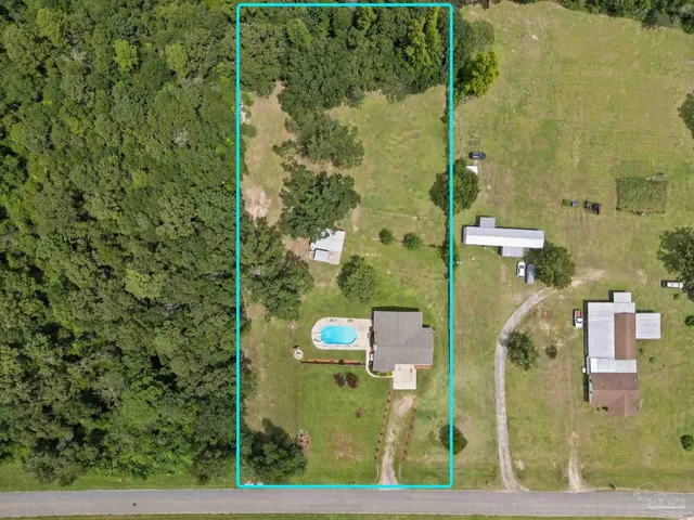 an aerial view of a residential apartment building with a yard