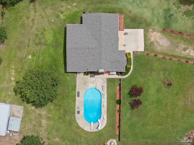 an aerial view of residential house with outdoor space and swimming pool