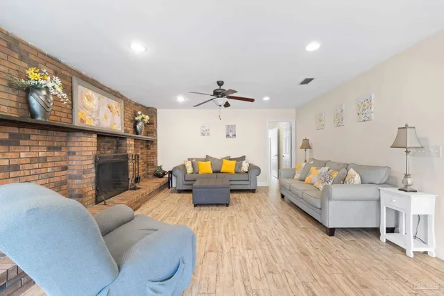a living room with furniture fireplace and a table