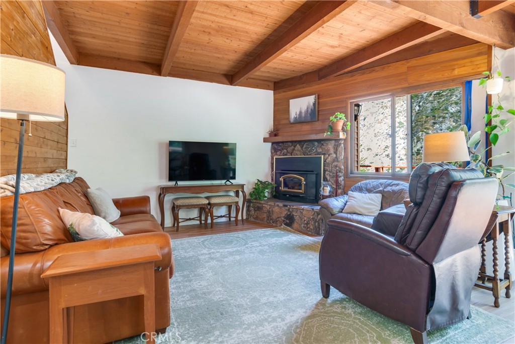 39444 Canyon Drive Forest Falls, CA 92339 - Photo 11 of 28 a living room with furniture a flat screen tv and a fireplace
