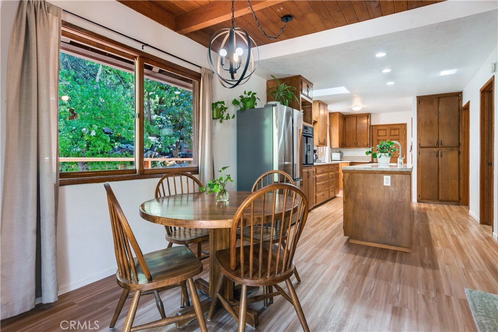 39444 Canyon Drive Forest Falls, CA 92339 - Photo 12 of 28 a dining room with furniture a chandelier and wooden floor