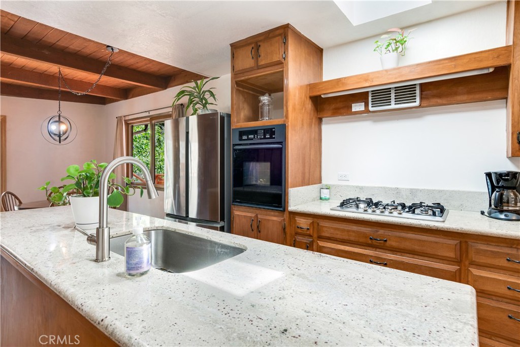 39444 Canyon Drive Forest Falls, CA 92339 - Photo 14 of 28 a kitchen with stainless steel appliances granite countertop a sink and a stove