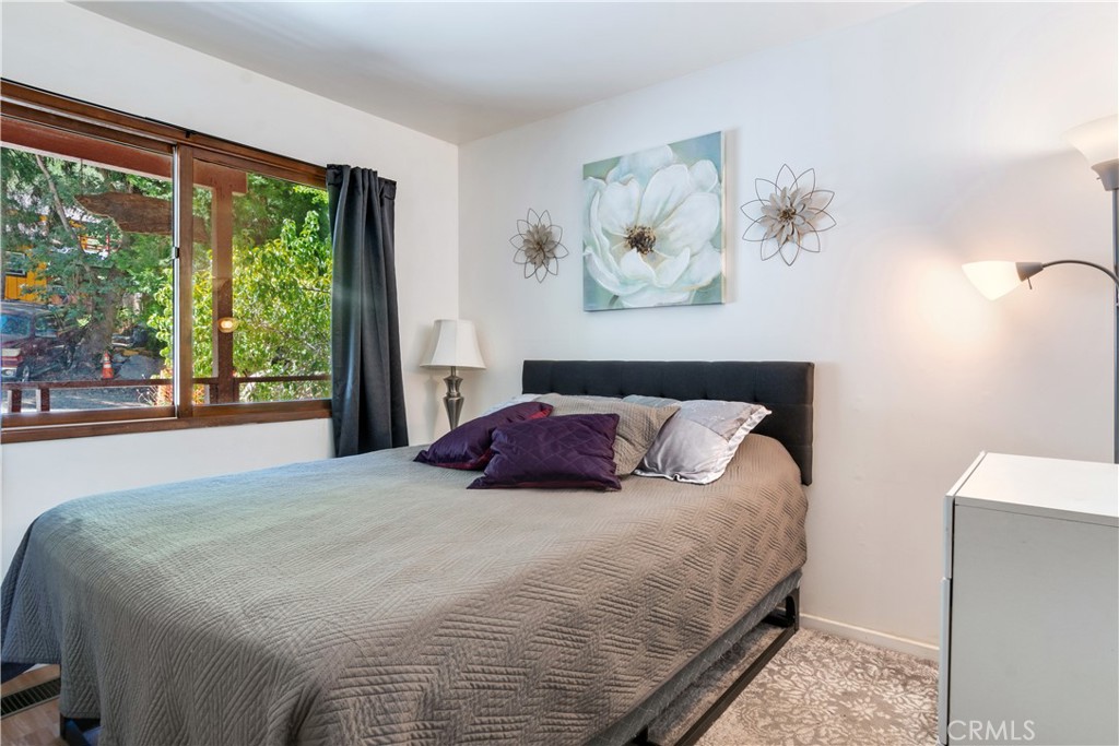 39444 Canyon Drive Forest Falls, CA 92339 - Photo 17 of 28 a large bed sitting in a bedroom next to a window