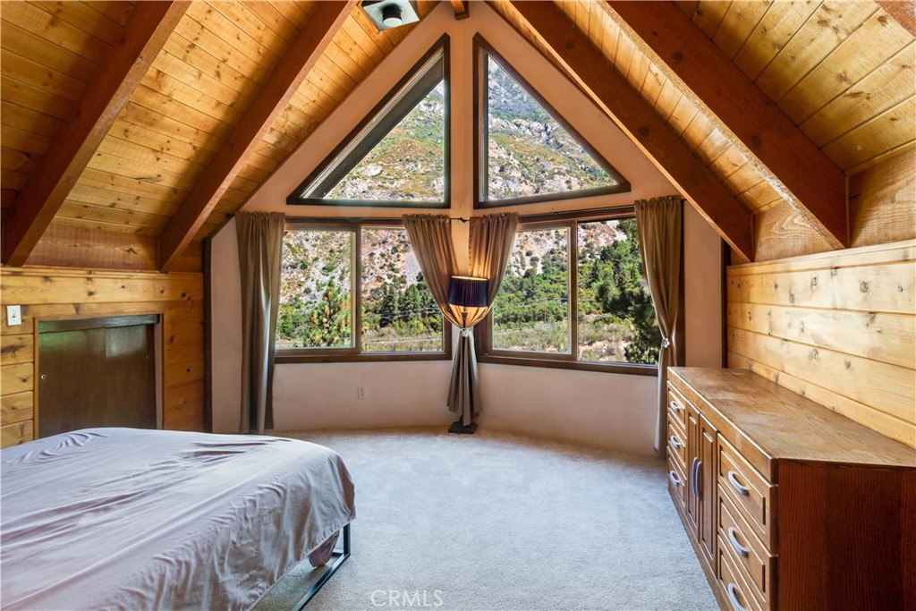 39444 Canyon Drive Forest Falls, CA 92339 - Photo 18 of 28 a bedroom with a bed and a large window with the view of outdoor