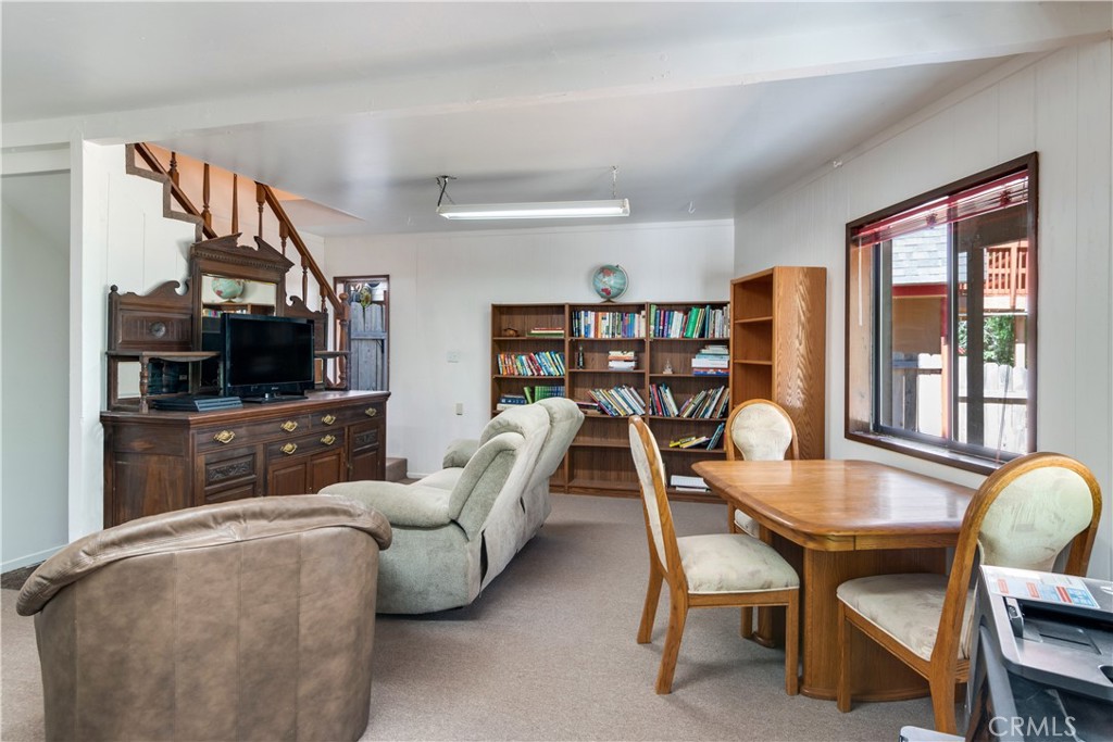 39444 Canyon Drive Forest Falls, CA 92339 - Photo 23 of 28 a living room with furniture a flat screen tv and a floor to ceiling window