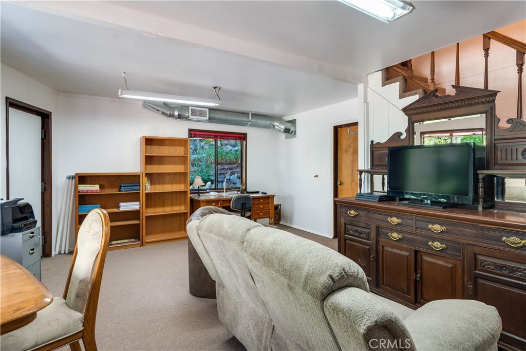39444 Canyon Drive Forest Falls, CA 92339 - Photo 24 of 28 a living room with furniture a flat screen tv and floor to ceiling window