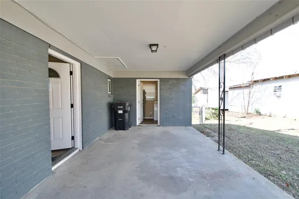 a view of a big room with windows and entryway