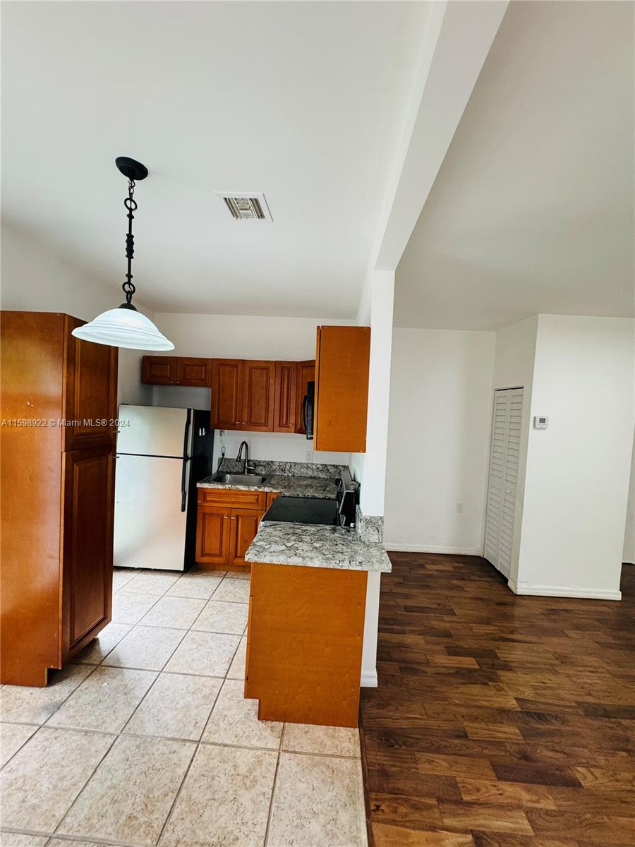 144 Northeast 43rd Street, Unit 2 Miami, FL 33137 - Photo 2 of 10 a kitchen with stainless steel appliances kitchen island granite countertop a refrigerator and a sink
