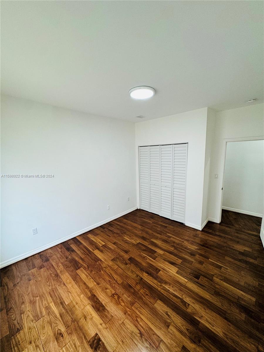 144 Northeast 43rd Street, Unit 2 Miami, FL 33137 - Photo 4 of 10 a view of empty room with wooden floor