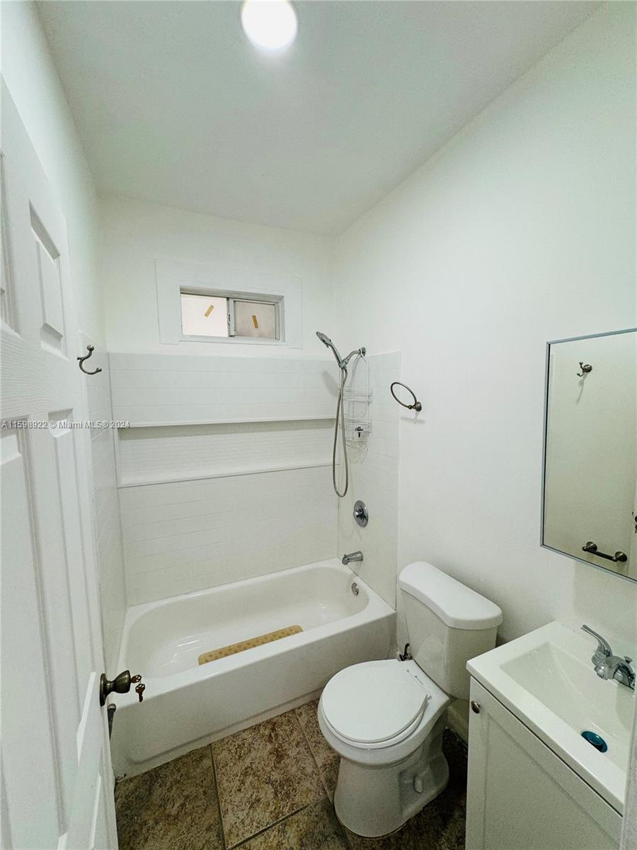 144 Northeast 43rd Street, Unit 2 Miami, FL 33137 - Photo 5 of 10 a bathroom with a toilet a sink and bathtub