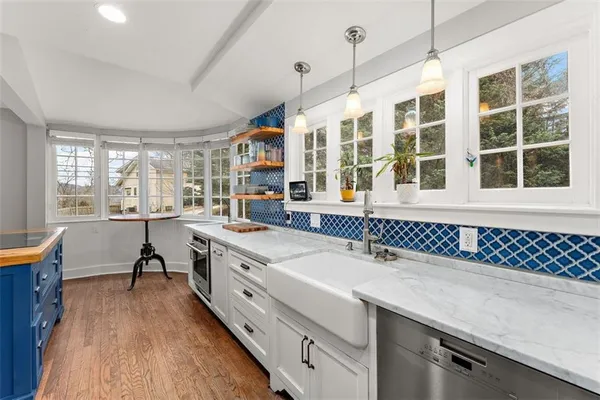 a kitchen with a sink stove and cabinets