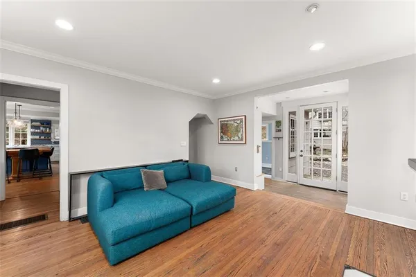 a living room with furniture and a wooden floor