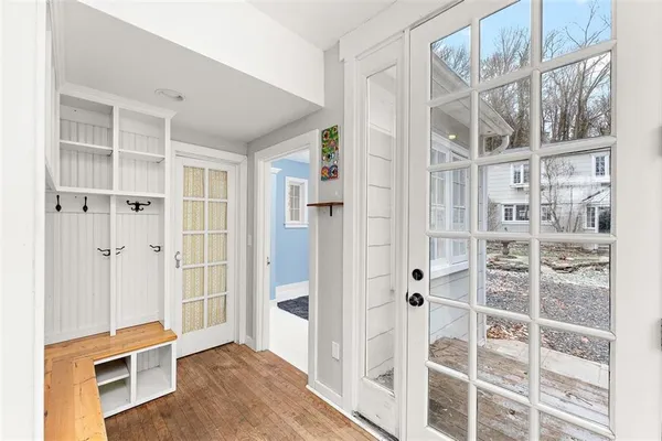 hallway view with wooden floor and entryway