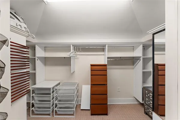 a view of walk in closet with empty racks