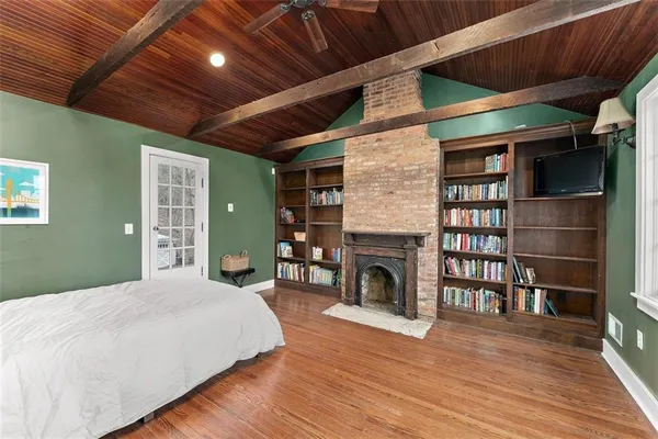 a bedroom with a bed and a fireplace