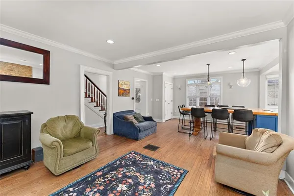 a living room with furniture ceiling fan and a rug