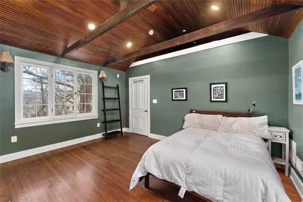 a bedroom with a large bed and a window
