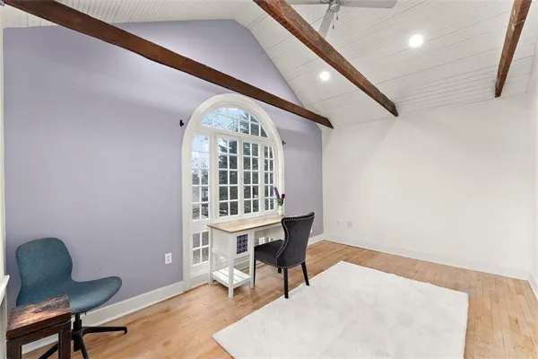a workspace with furniture window and wooden floor