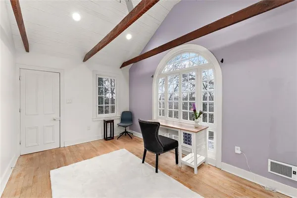 a workspace with furniture window and wooden floor