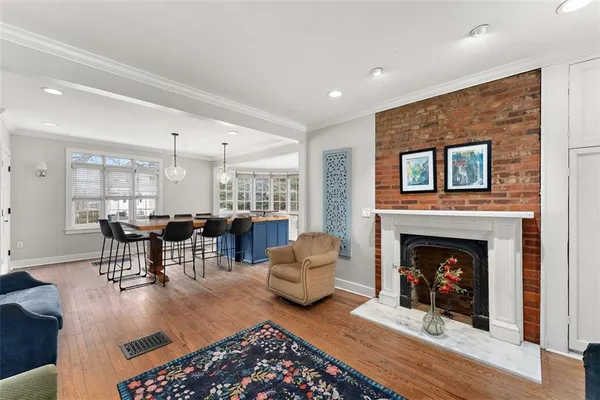 a living room with furniture a fireplace and a table